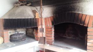 an old brick oven with a wheel in it at Begovi Dvori in Rab