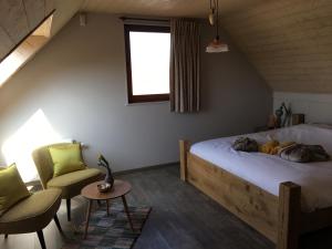 Postel nebo postele na pokoji v ubytování B&B De Hostelier