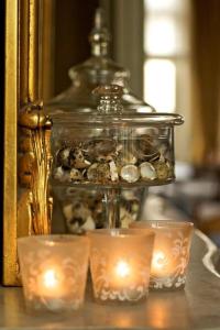 a glass container filled with stones and candles on a table at Hotel Ter Duinen in Bruges