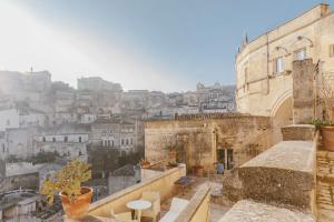 a stone building with a clock on it's side at Hotel Sassi in Matera