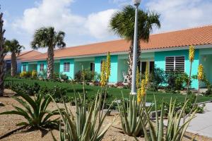a building with palm trees in front of it at Blije Rust 10 in Willemstad