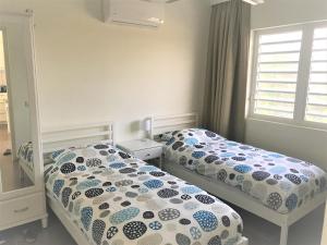 two twin beds in a bedroom with a window at Blije Rust 10 in Willemstad +23 photos