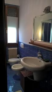 a bathroom with two sinks and a mirror at Le Betulle in Zanica