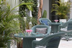 a group of tables and chairs on a patio at Riad Idra in Marrakech