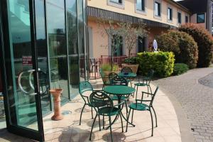 a patio with tables and chairs in front of a building at Hotel Semifonte in Poggibonsi