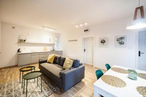 a living room with a couch and a table at Apartamenty toruńskie pod Krzywą Wieżą in Toruń +31 photos
