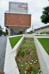 un jardín de flores frente a un edificio en Hotel Sree Annamalaiyar Park, en Tirunelveli