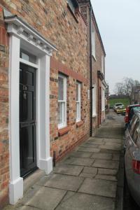 a brick building with a door on the side of it at Kyme Street, central York in York