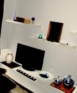 a desk with a computer monitor and a keyboard at Le Moment Bleu in Strasbourg