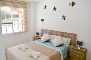 Cama ou camas em um quarto em Residencial Playa Paraiso
