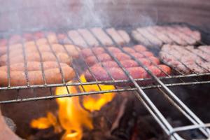 a bunch of sausages cooking on a grill at Boho 27 Hostel Marrakech in Marrakesh