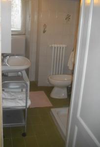 a bathroom with a toilet and a sink at La Corte del Frate in Podere Panzano