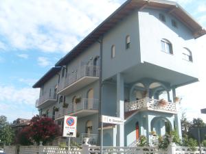 a white building with balconies on the side of it at Hotel GF in Cesano Boscone
