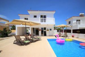 a house with a swimming pool with a pink swan in the water at Katerina in Ayia Napa