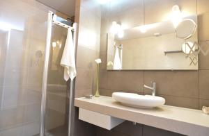 a bathroom with a sink and a mirror and a shower at Casas do Pinheiro in Cedros