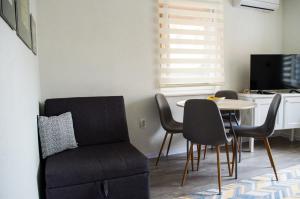 a living room with a chair and a table at Apartment Fortuna in Visoko