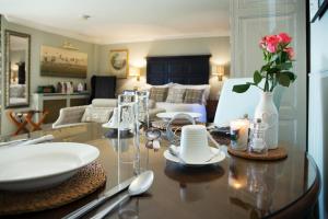 a living room with a table with a vase of flowers on it at Luxury Escape in Hunstanton