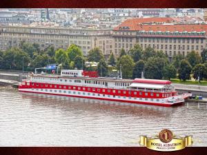 a large red and white boat in the water at Botel Albatros in Prague