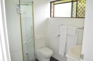 a white toilet sitting next to a shower in a bathroom at Best Western Ipswich in Ipswich