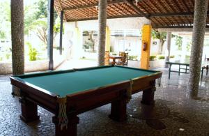 a pool table in the middle of a patio at Chalés Village Gales in Maragogi