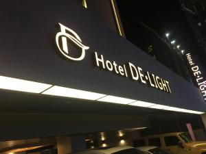 a sign for a hotel display at night at Delight Hotel Jamsil in Seoul