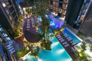an overhead view of a swimming pool with chairs and trees at Panan Krabi Resort - SHA Plus in Ao Nang Beach