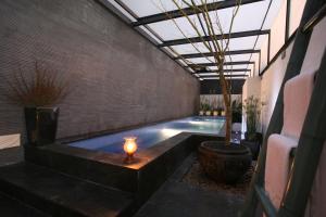 a swimming pool with a candle in the middle at Chateau Boutique Motel in Taichung