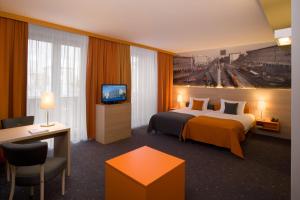 a hotel room with a bed and a television at Hotel MDM City Centre in Warsaw