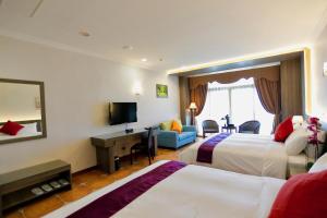 Łóżko lub łóżka w pokoju w obiekcie Kending Kaying Hotel