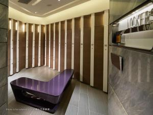 a purple bench in a room with wooden walls at Royal Plaza Hotel in Hong Kong