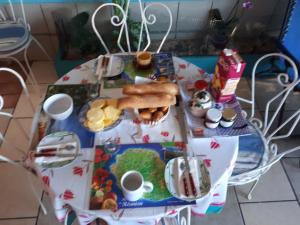 a table with a plate of food on it at Sweet Home in Saint-Joseph