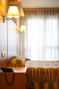 A bed or beds in a room at Hotel La Polar