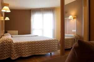 A bed or beds in a room at Hotel La Polar