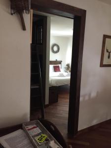 a room with a bedroom with a ladder and a bed at Relax holiday in Sestriere