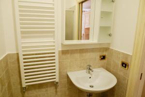 a bathroom with a white sink and a mirror at Melusina Rialto Venice Center in Venice