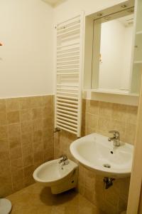 a bathroom with a sink and a mirror at Melusina Rialto Venice Center in Venice