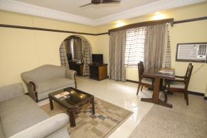 a living room with a couch and a table at Lytton Hotel in Kolkata