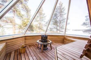 an empty room with a large window in a house at Wilderness Hotel Inari & Igloos in Inari