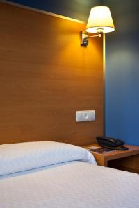 A bed or beds in a room at Hotel La Polar