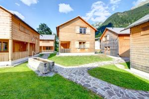 a house with a stone walkway in the yard at CASALPIN Chalets in Brand