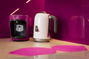a pink and white appliance sitting on a table at APARTAMENT ELEGANCE PINK in Rewal