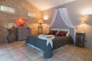 a bedroom with a bed with a canopy at Domaine Jobert in Aubagne