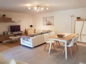 a living room with a couch and a table at Maison Provencale in Cavalaire-sur-Mer