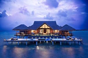 a house on a dock in the middle of the water at Taj Exotica Resort & Spa in South Male Atoll