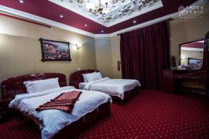 a hotel room with two beds and a mirror at Rabigh Tower Hotel in Rabigh