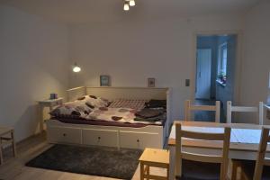 a bedroom with a bed and a table and chairs at Fewo Grenzach in Grenzach-Wyhlen