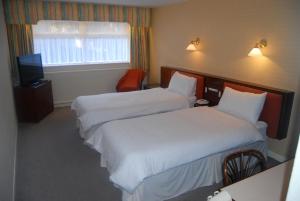 A bed or beds in a room at Brecon Hotel Sheffield Rotherham