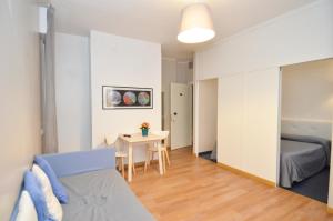 a small apartment with a bed and a table at Ute Hotel in Lido di Jesolo