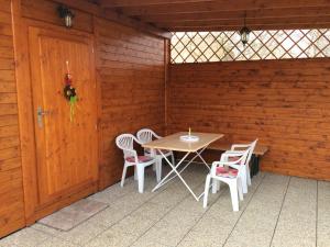 Habitación de madera con mesa, sillas y puerta en Chata v Šatově, en Šatov