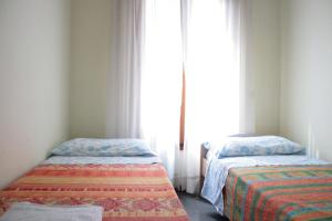 A bed or beds in a room at Melusina Bocca di Piazza Venice Historical Center